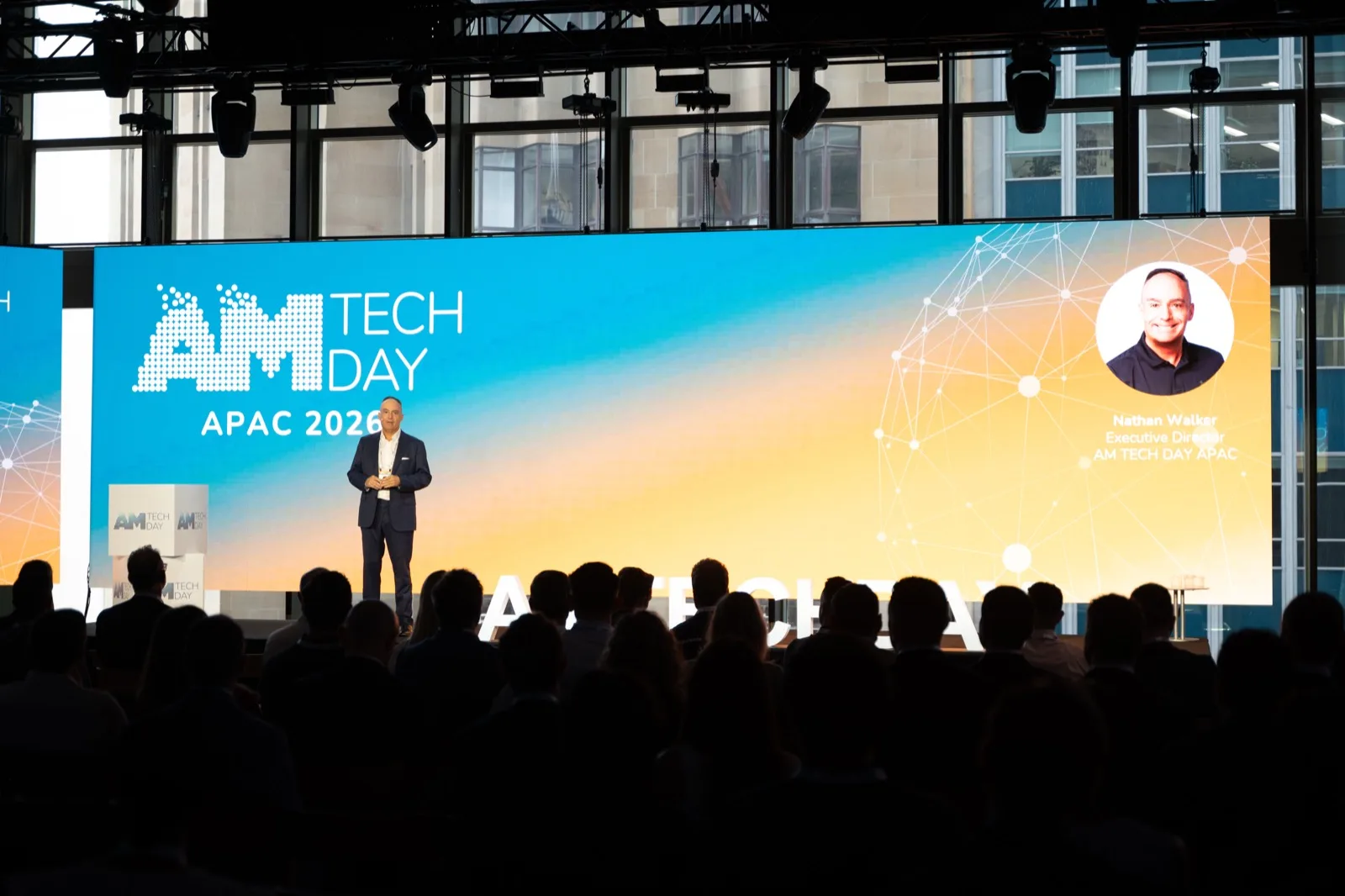 Keynote speaker presenting to a full room from the main stage