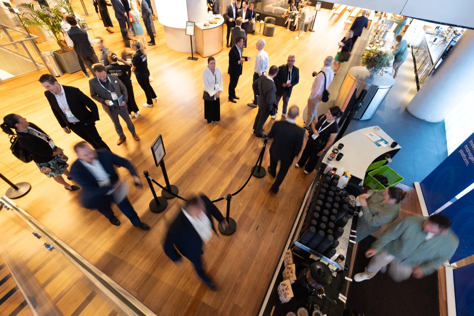 Delegates networking across the exhibition floor between sessions