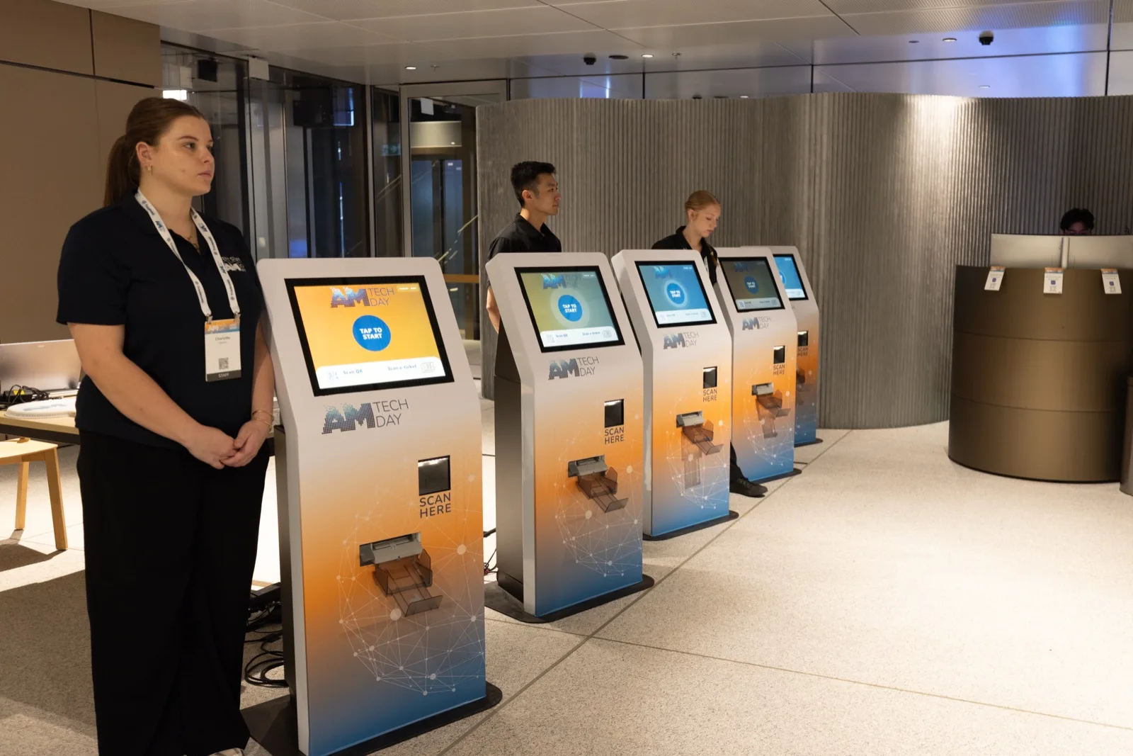 Event staff at the self-service registration kiosks